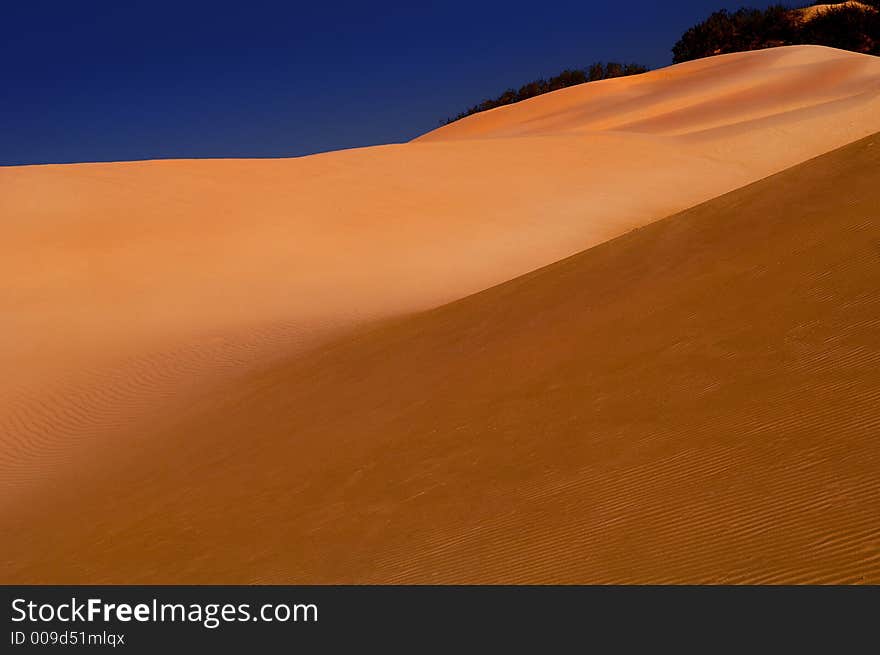 Beautiful lonely sand dunes with blue sky. Beautiful lonely sand dunes with blue sky