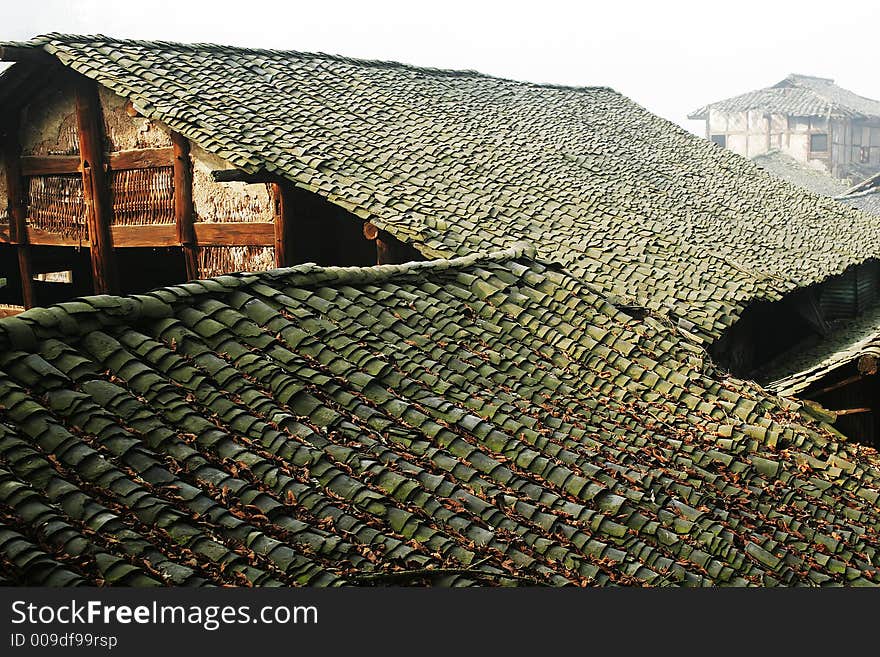 Old folk house with tile roof in morning sunlight