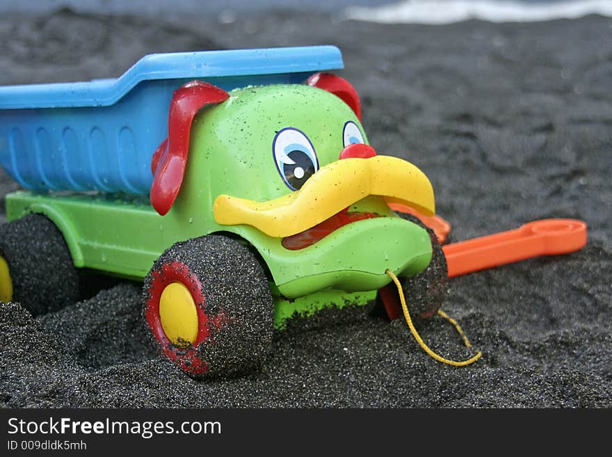 Toy truck in black sand