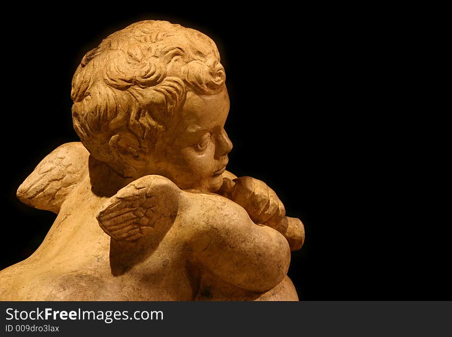 Little angel in church with black background.