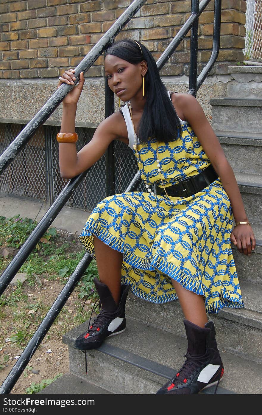 This is an image of a female model relaxing on the stairs of an urban environment. This is an image of a female model relaxing on the stairs of an urban environment.