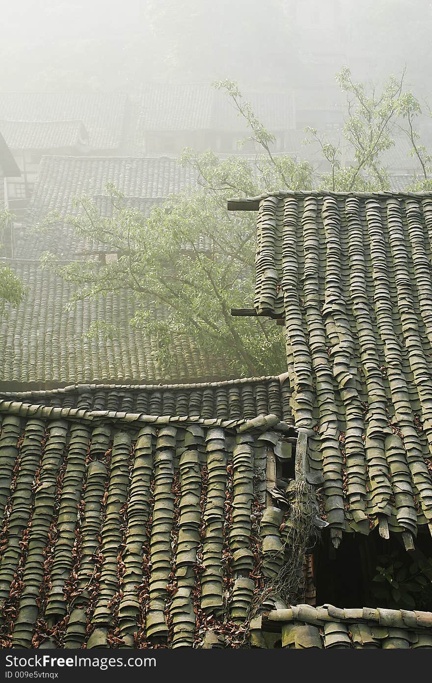 Old folk house with tile roof in morning sunlight