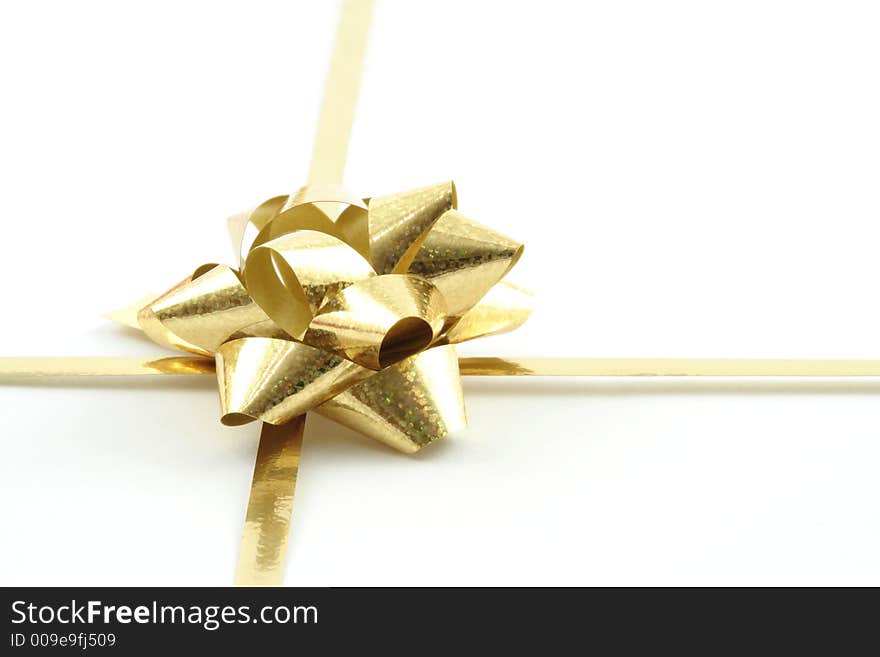 Gold gift ribbon on a white background