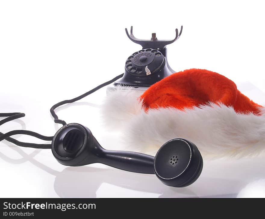 Red Santa claus hat and old telephone