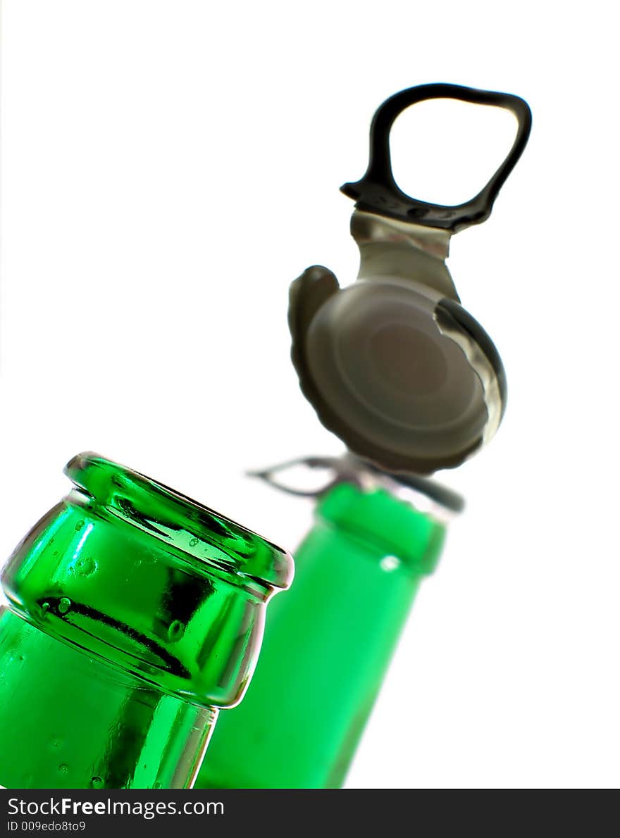 Opening beer bottle isolated over white background