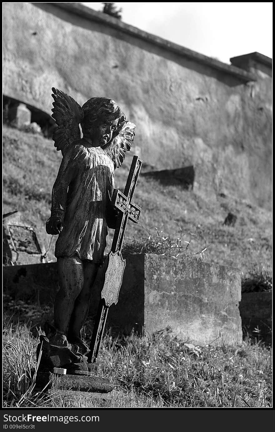 Very old angel on grave of litle child-only 3 moths old. This old graveyard where is this grave is situated in Banska Stiavnica. Very old angel on grave of litle child-only 3 moths old. This old graveyard where is this grave is situated in Banska Stiavnica.