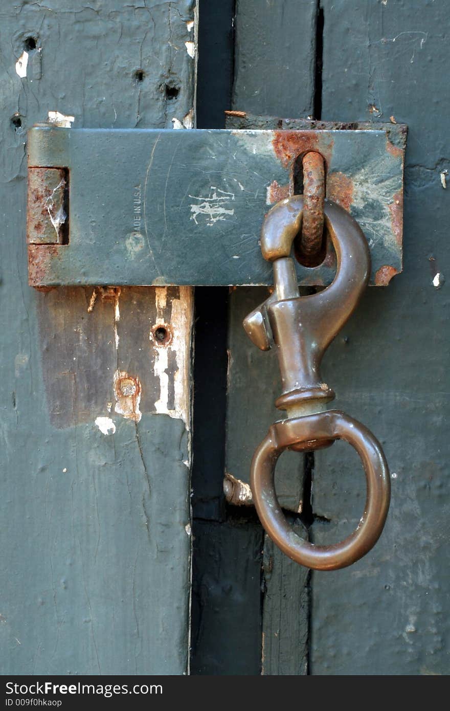 This is a close up image of the latch on a shed door. This is a close up image of the latch on a shed door.