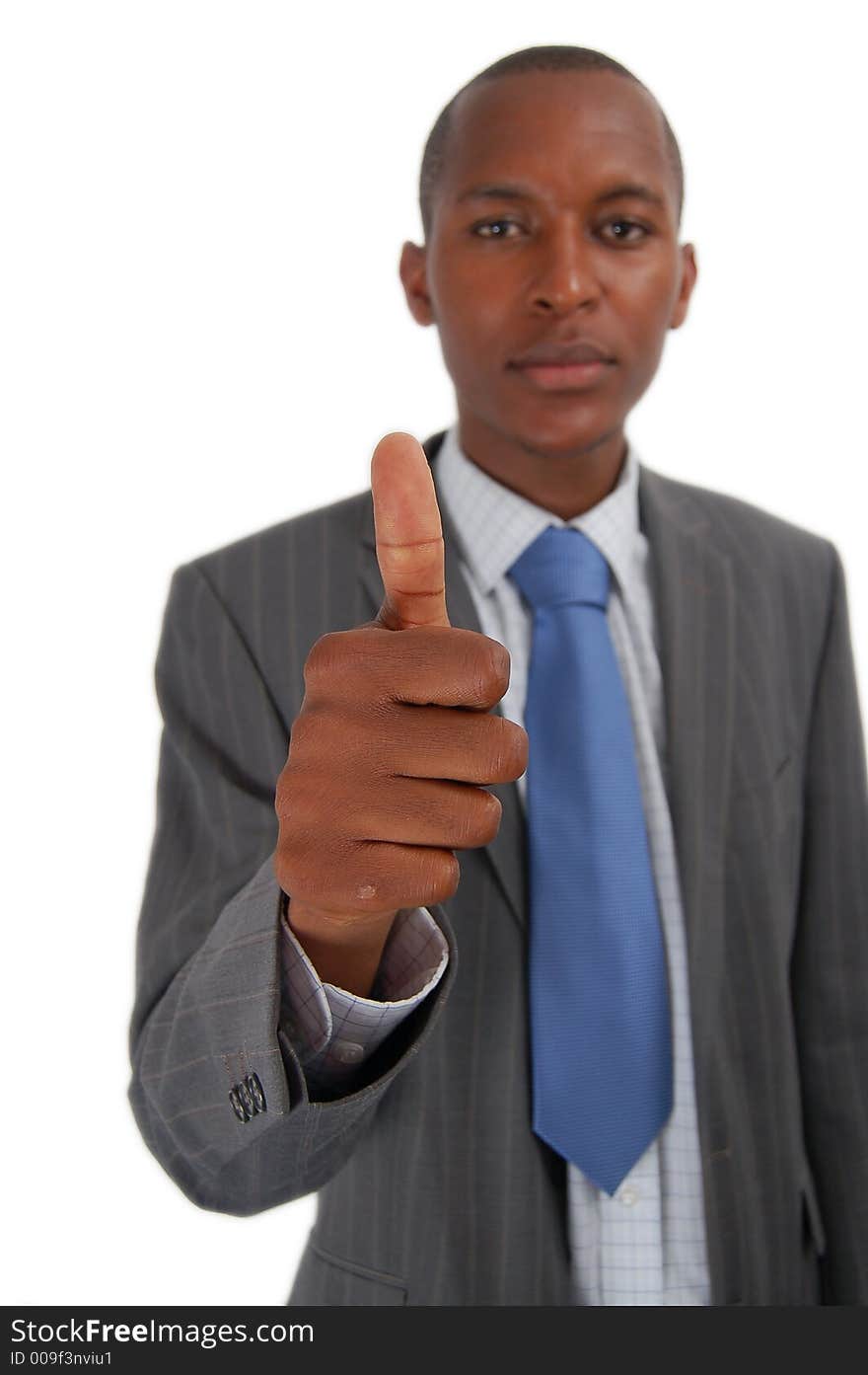 This is an image of business, happily giving the thumbs up. The thumb is in focus. This is an image of business, happily giving the thumbs up. The thumb is in focus.