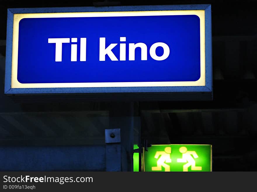 An illuminated sign, showing the way to the cinema,Norwegian text. An illuminated sign, showing the way to the cinema,Norwegian text