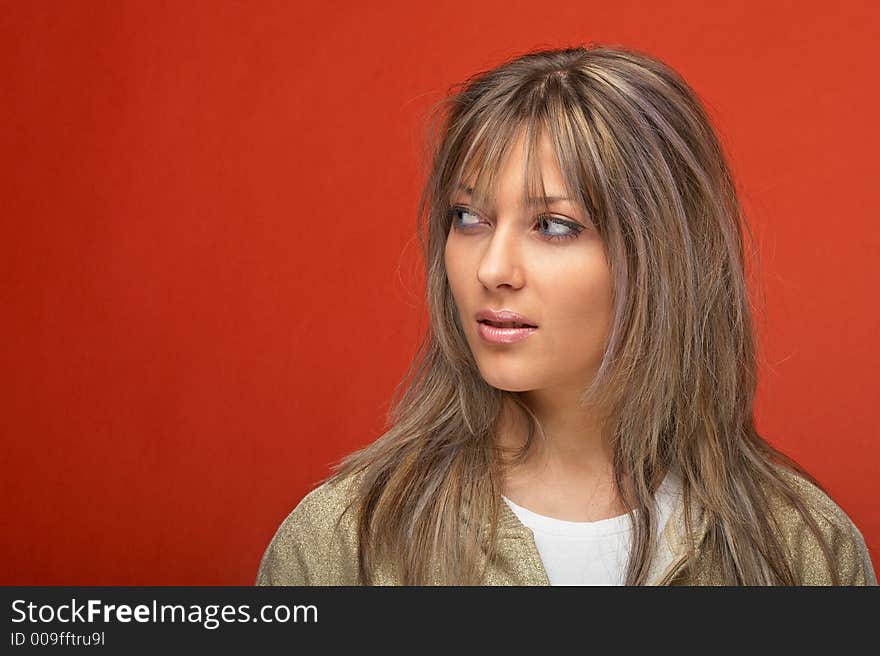 young woman over orange background with a look