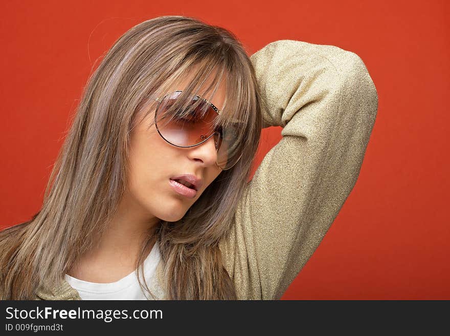 young woman over orange background with a look