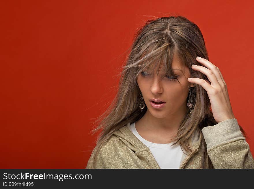 young woman over orange background with a look