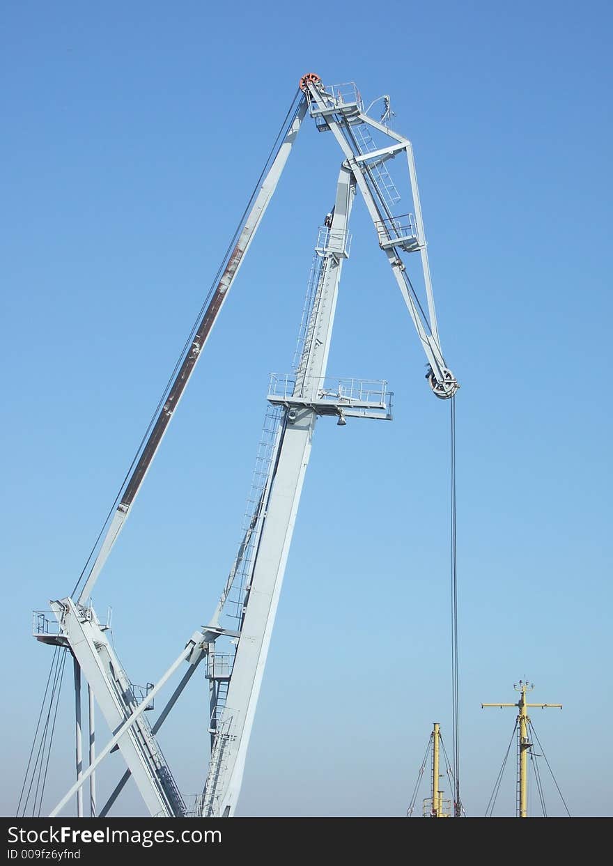 Photo of a loading crane on sky background