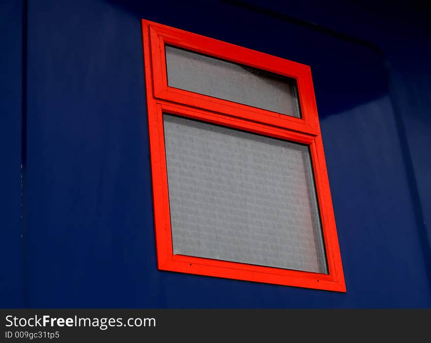 Red window frame with blue walls