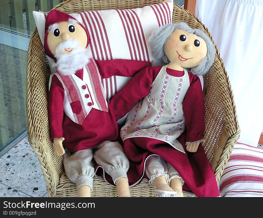 Ground parents dolls siting on chair. Ground parents dolls siting on chair