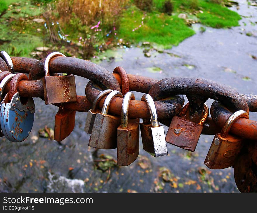 Rusty padlocks over river