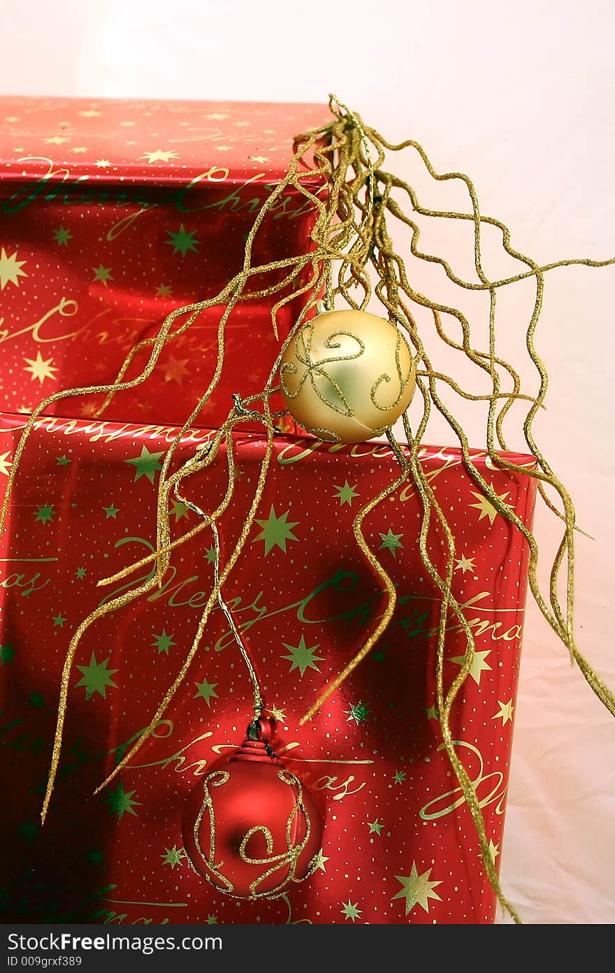 Red and gold wrapped presents with Christmas ornaments. Red and gold wrapped presents with Christmas ornaments