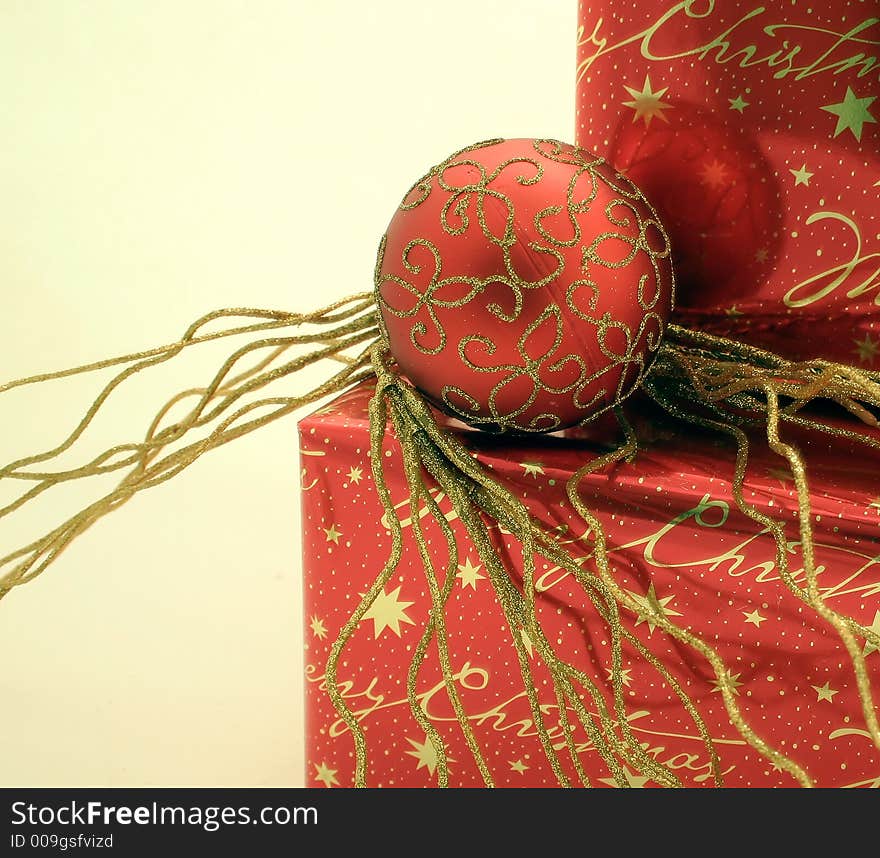 Red and gold wrapped presents with Christmas ornaments. Red and gold wrapped presents with Christmas ornaments