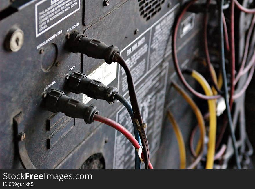 Dusty connections on the back of smog test machine in a mechanic shop