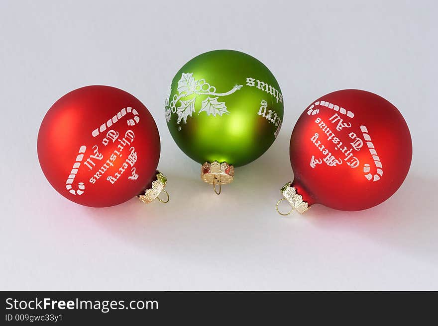 Three christmas balls. Two reds and one green.