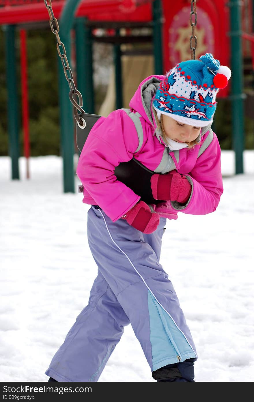 Little girl on playground at winter. Seneca Creek State Park, Maryland, USA