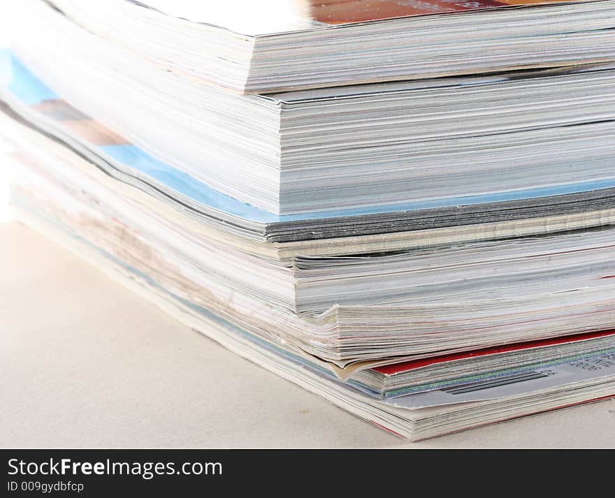 Stack of colourful magazines on white background. Stack of colourful magazines on white background