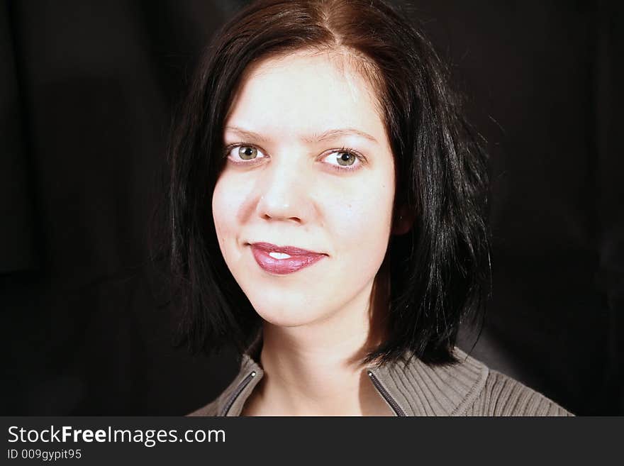 Young woman smiling on black