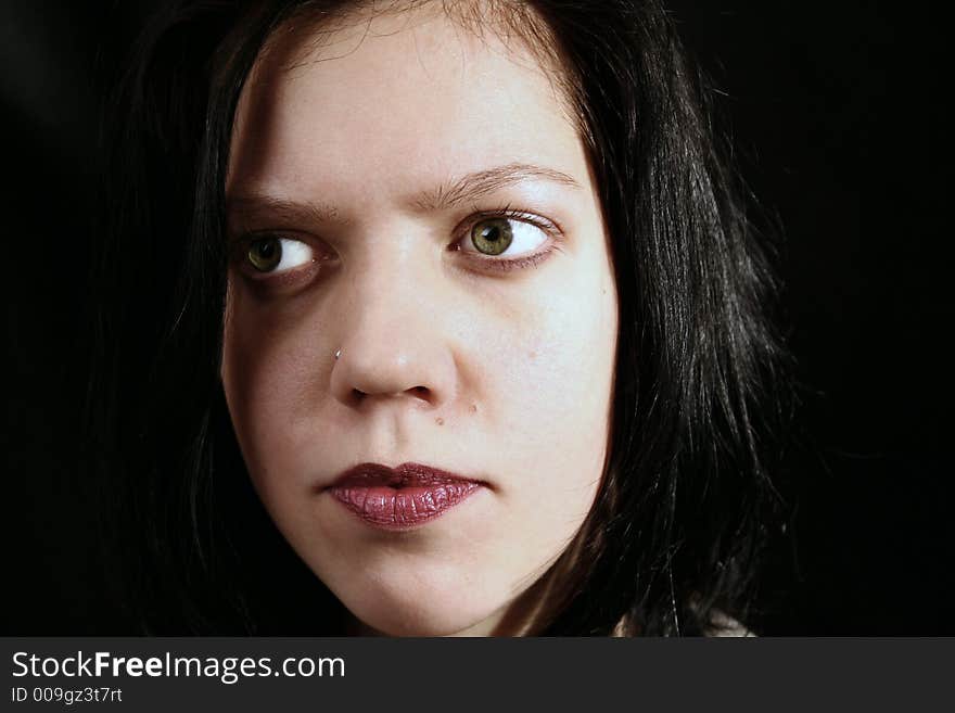 Young woman portrait, close up on black background. Young woman portrait, close up on black background