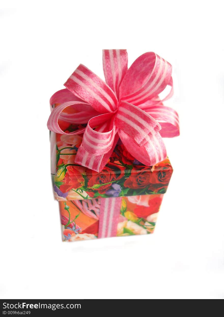 A red ribbon tied in a flowered bow over a white background