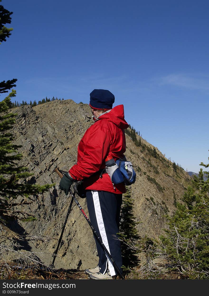 This image of the hiker checking out the destination mountains summit was taken in NW Montana. This image of the hiker checking out the destination mountains summit was taken in NW Montana.