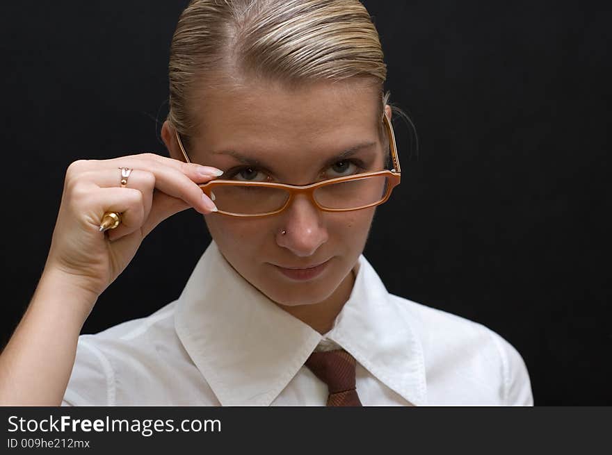 Business woman with pen and orange glasses isolated on black