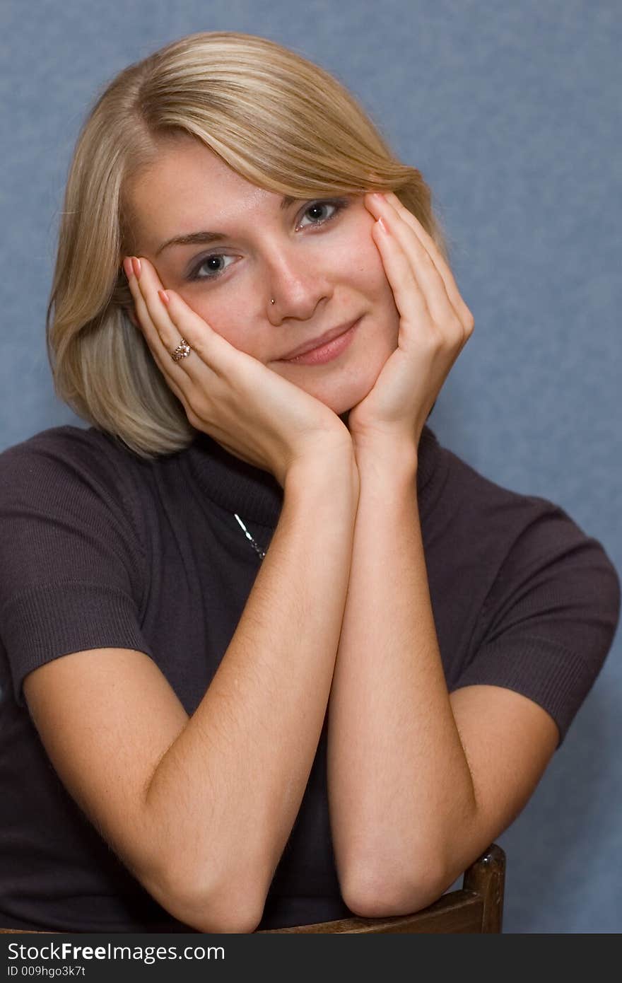 Portrait of a blond girl with blue background