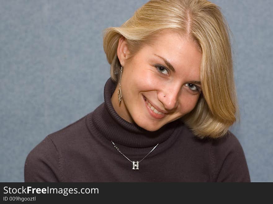 Portrait of a blond girl with blue background