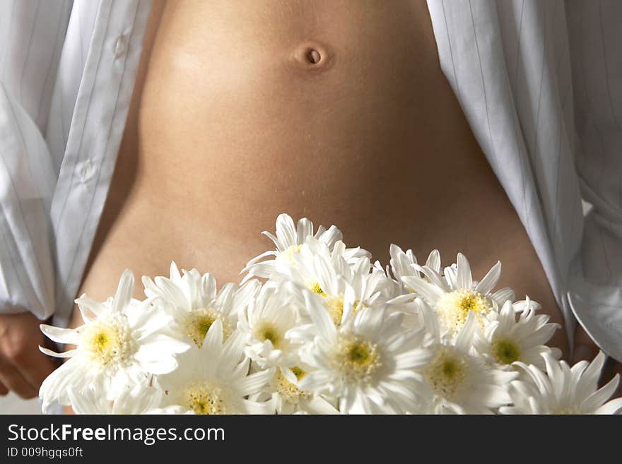 Woman's belly and white flowers. Woman's belly and white flowers