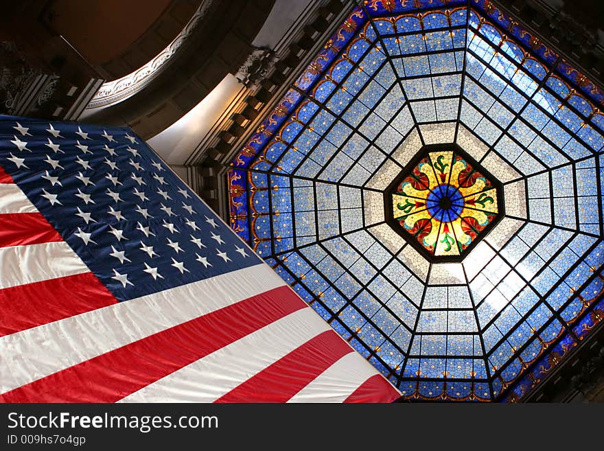 American flag upwards to stained glass skylight. American flag upwards to stained glass skylight