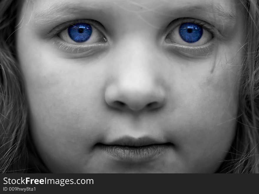 Black and white image of young girl: selective colorization; saturation. Haunting, moody image. Black and white image of young girl: selective colorization; saturation. Haunting, moody image.