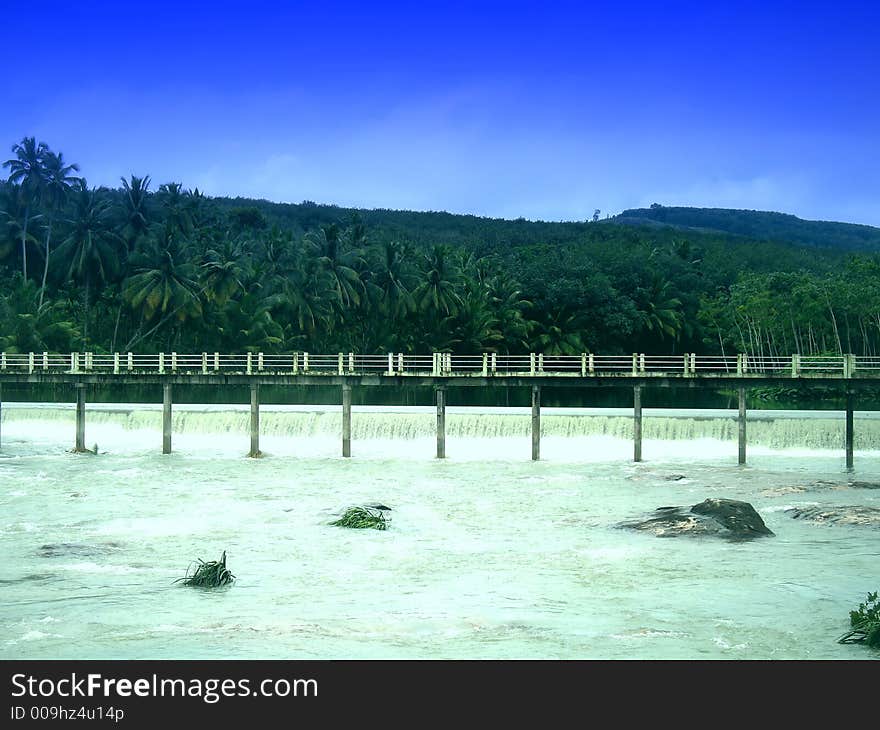 Flooded river with narrow bridge to cross. Flooded river with narrow bridge to cross.