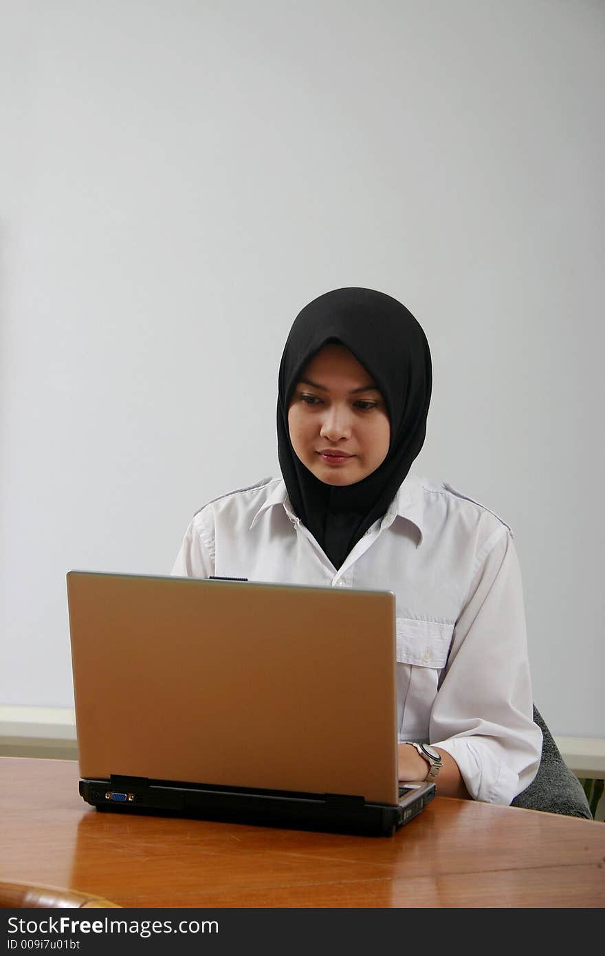 An asian girl using a laptop. An asian girl using a laptop.