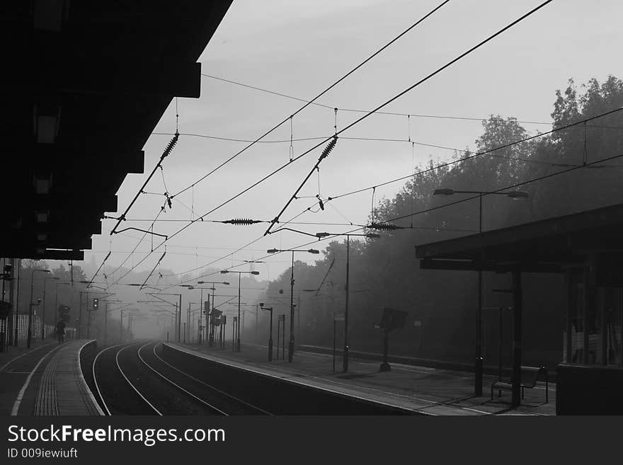 Looking down a railway train station on a misty morning. Looking down a railway train station on a misty morning