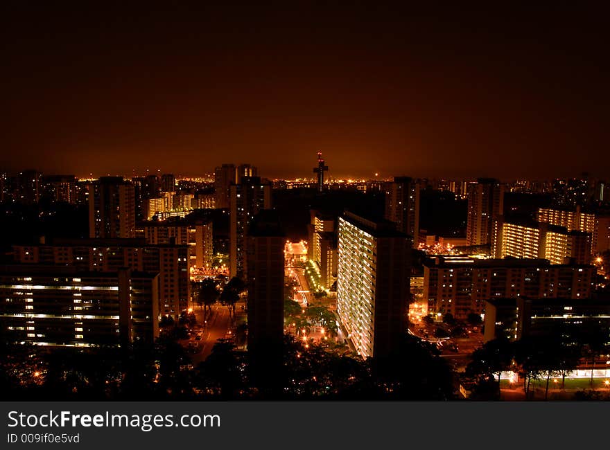 The orchestra of the HDB flats at night light, conduced by the cross tower