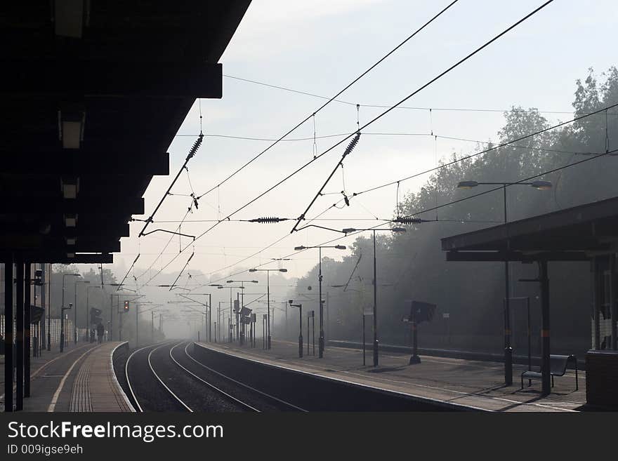 Looking down a railway train station on a misty morning. Looking down a railway train station on a misty morning