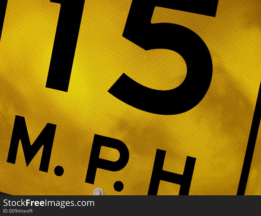 Sectional shot of road sign stating speed limit.