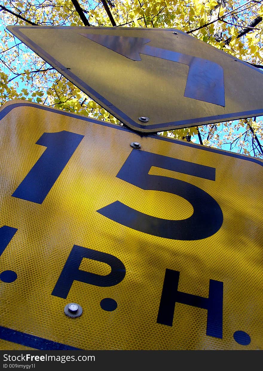 Sectional shot of road sign stating speed limit and turn restrictions.