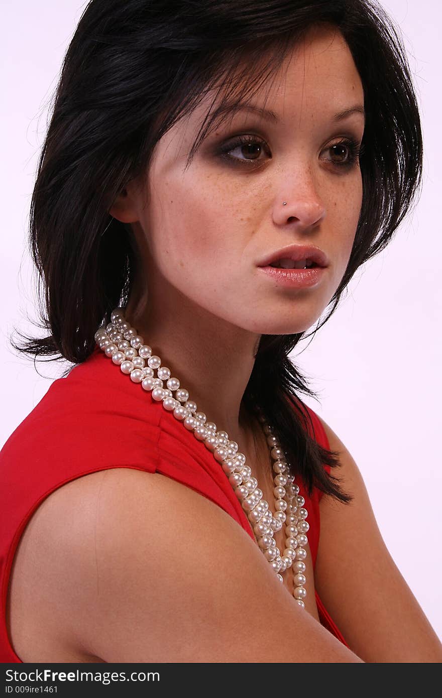 Asian model with pearls and a red dress.