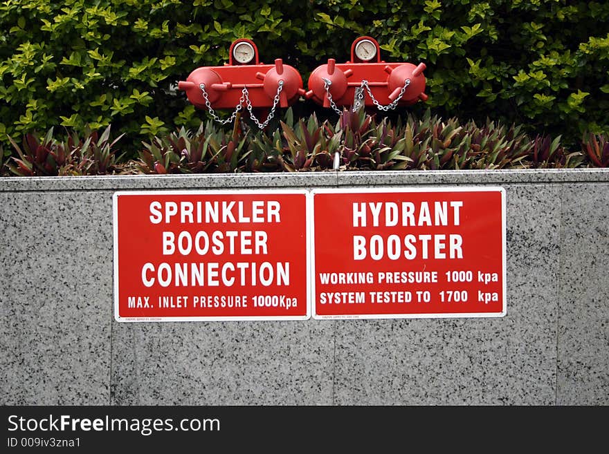 Booster and hydrant point on a new building with signs. Booster and hydrant point on a new building with signs