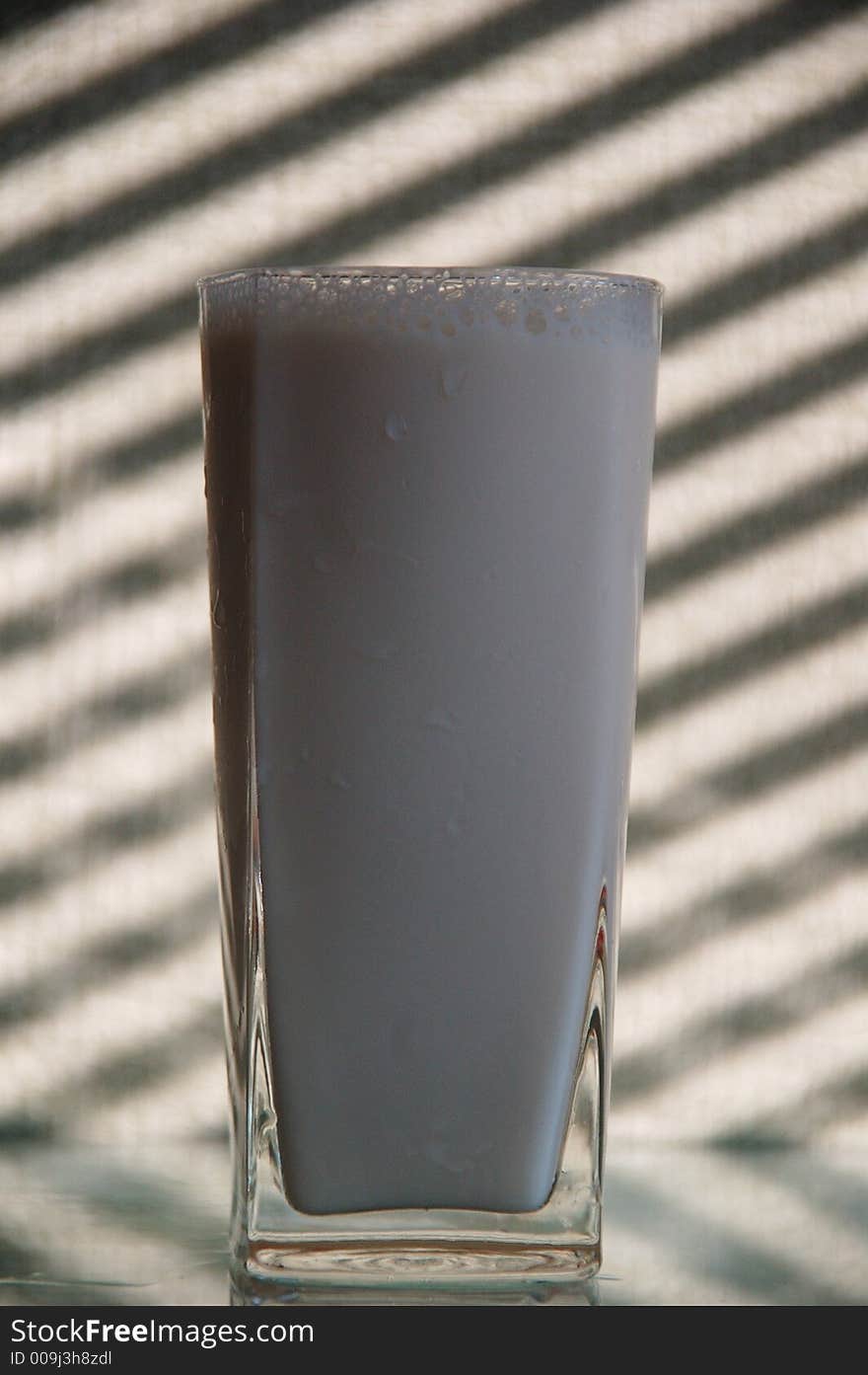 Glass with milk and black-white stripes