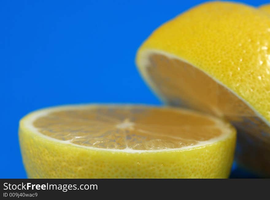 Lemon Halves Over Blue Background. Shallow DOF. Lemon Halves Over Blue Background. Shallow DOF.