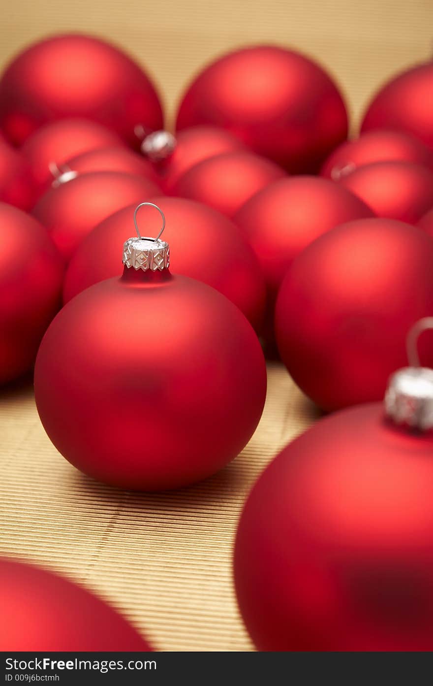 Red christmas decoration on gold background.