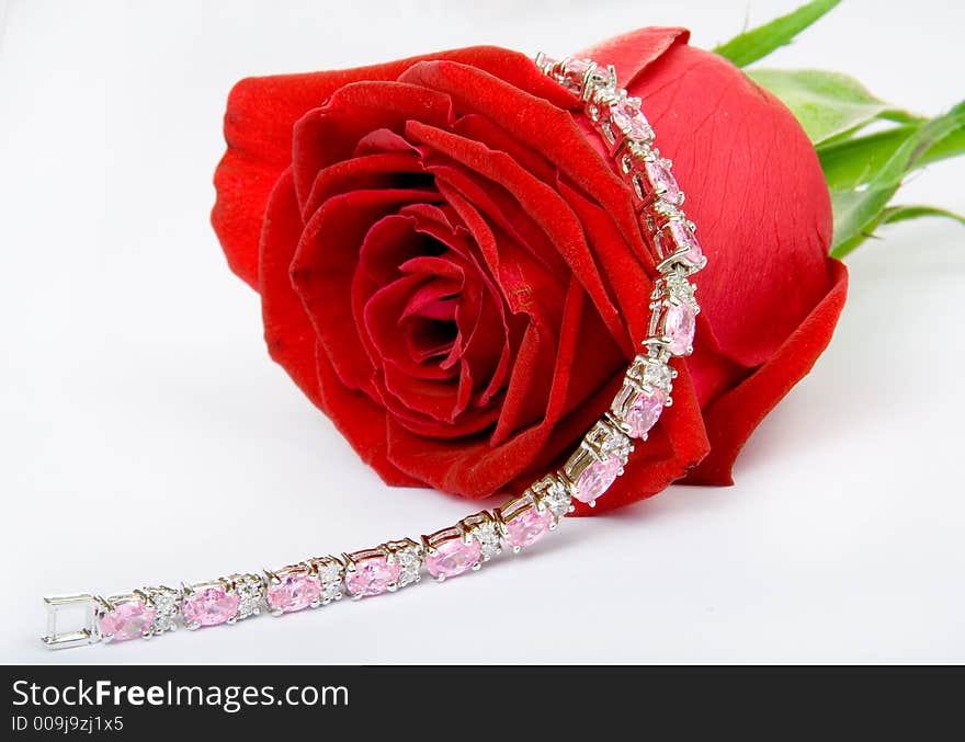 Beautiful red rose with jewelery on it, ISOLATED on white. Beautiful red rose with jewelery on it, ISOLATED on white