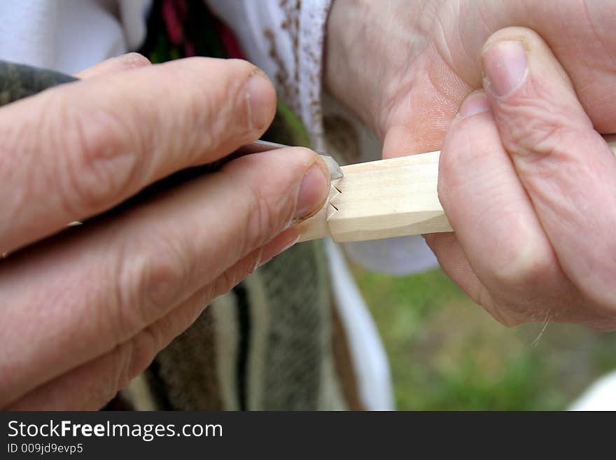 Craftsman using tools for making a spoon